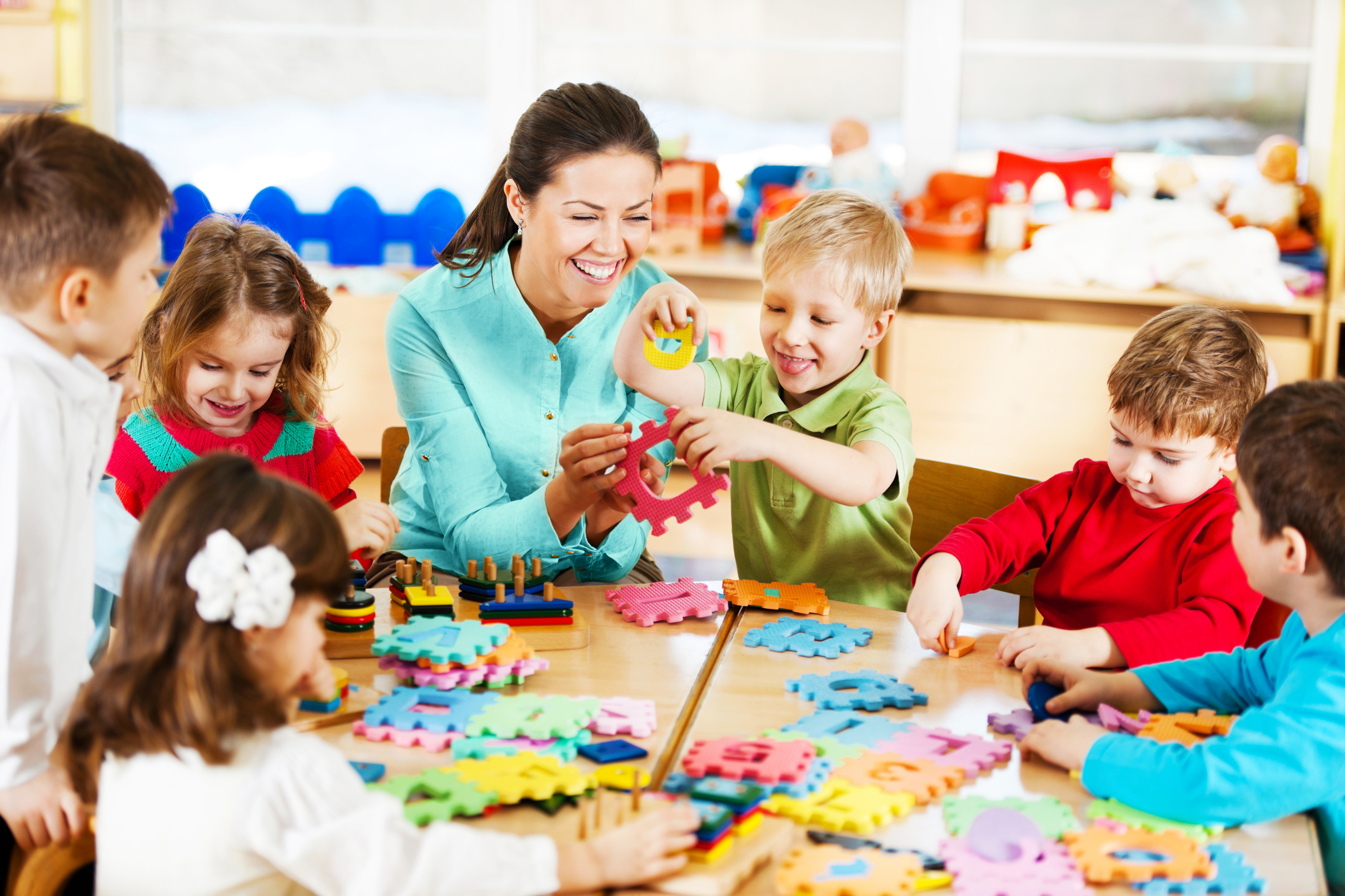 Nursery teacher playing with the kids.